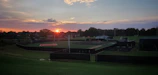 Baseball field at sunset, symbolizing the passion behind the app’s creation.