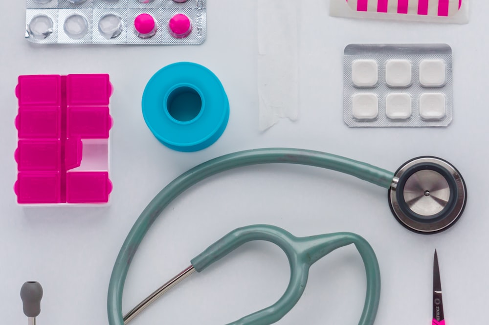 green and black stethoscope on white printer paper