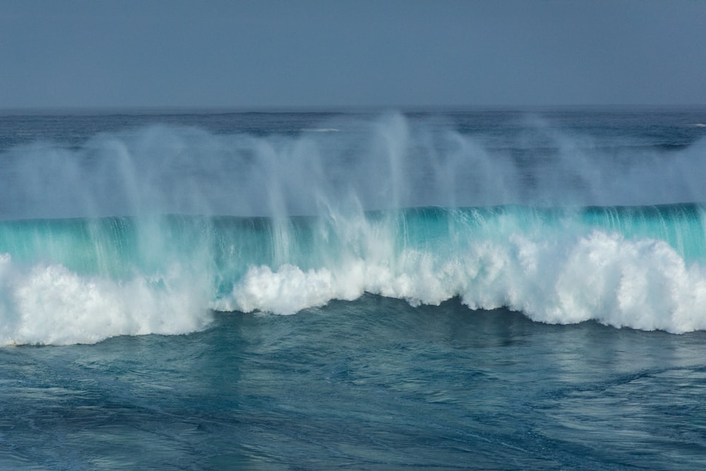 ocean waves crashing on shore during daytime