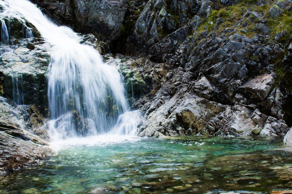 water falls on rocky mountain