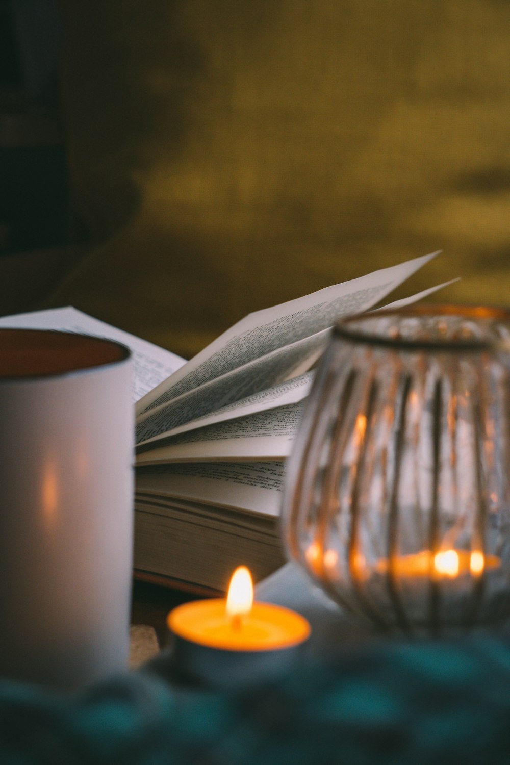 white pillar candle beside clear glass candle holder