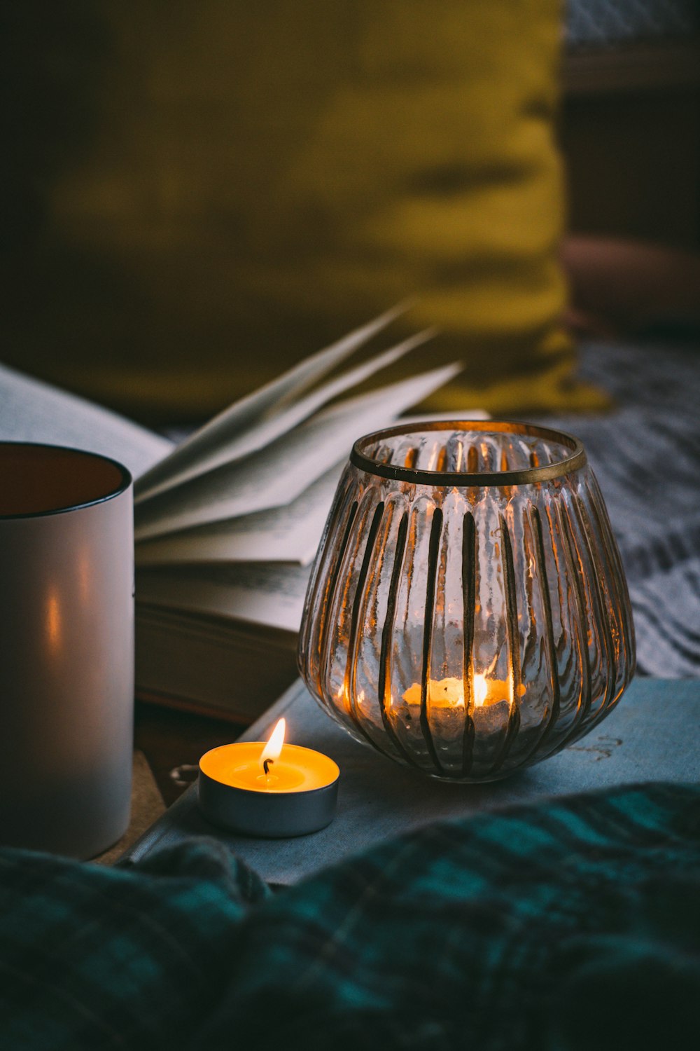 lighted candle in clear glass candle holder