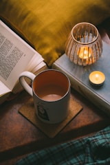 white ceramic mug beside clear glass jar