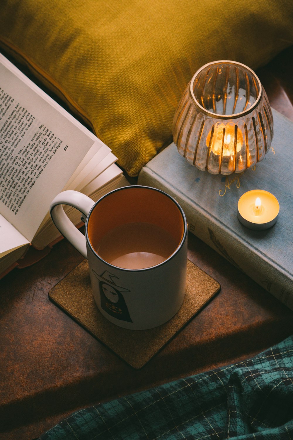 white ceramic mug beside clear glass jar