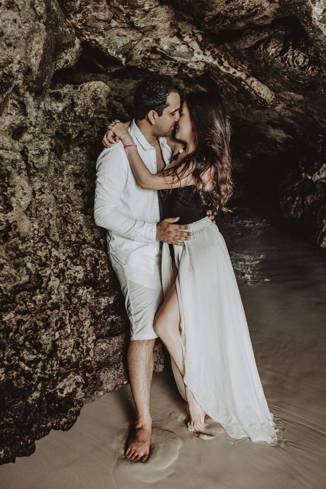 woman in white dress hugging man in white dress shirt