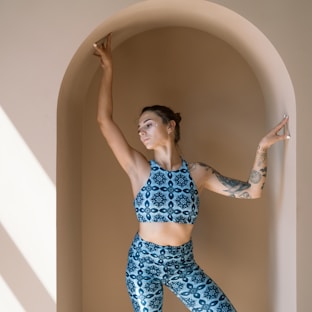 woman in blue and white polka dot bikini standing on bathtub