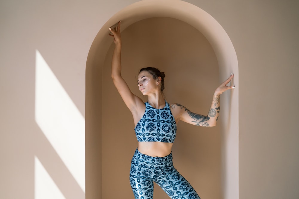 woman in blue and white polka dot bikini standing on bathtub