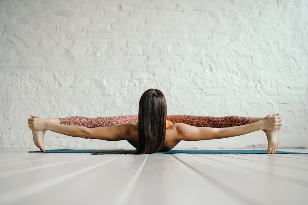 woman in blue and red bikini lying on blue hammock