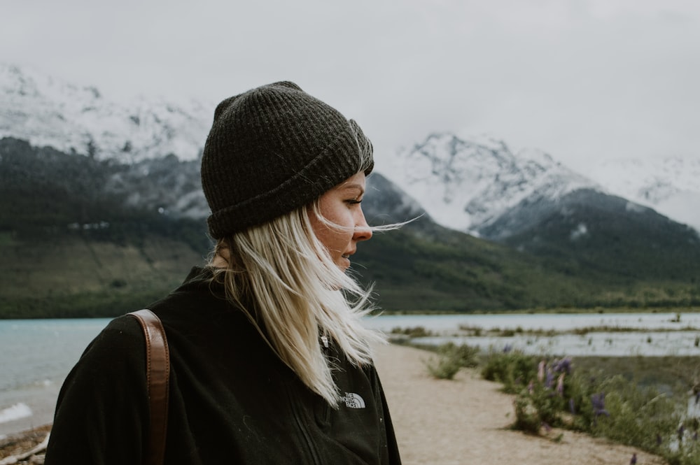 woman in black knit cap and black jacket