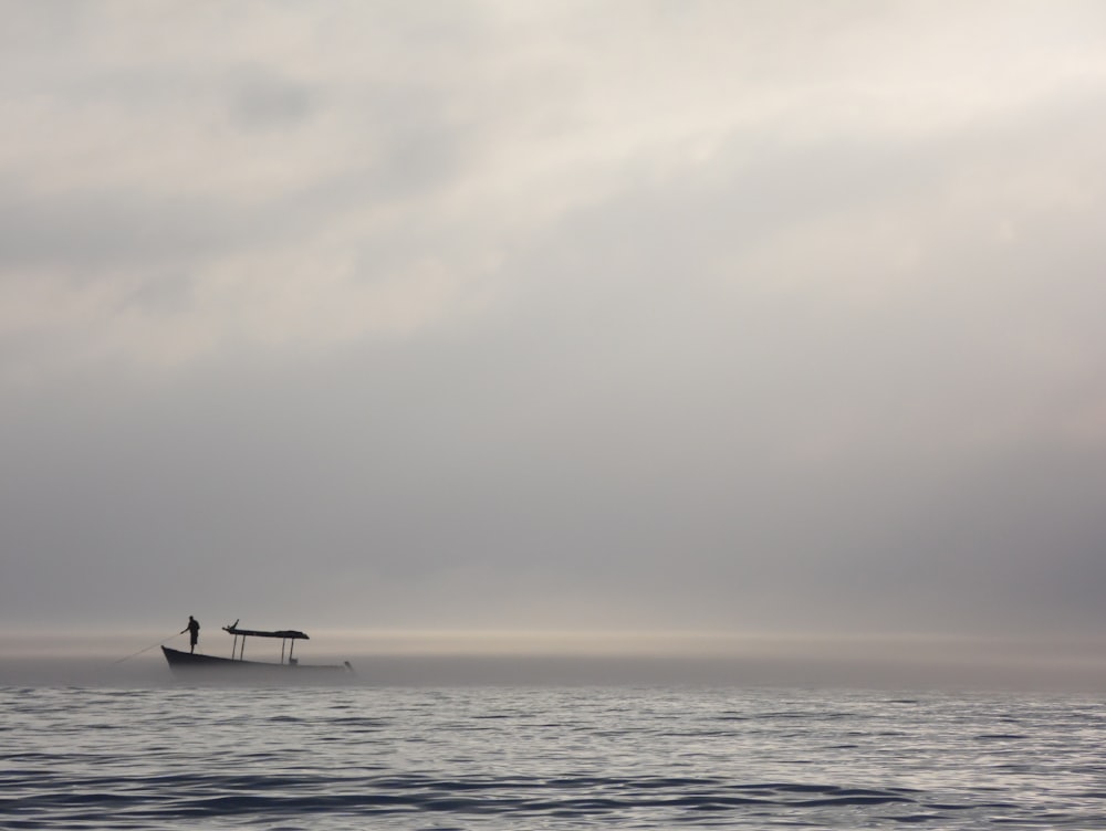 person riding on boat on sea during daytime