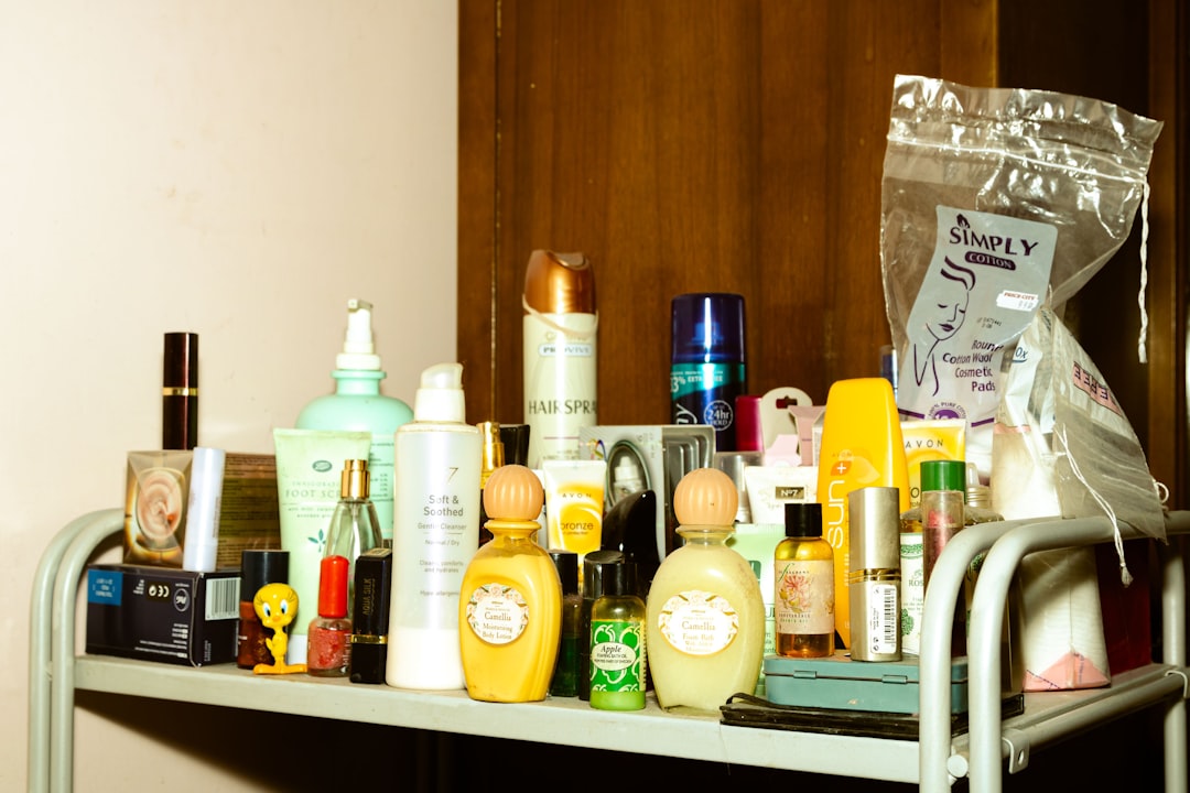 white and yellow plastic bottle on brown wooden shelf,