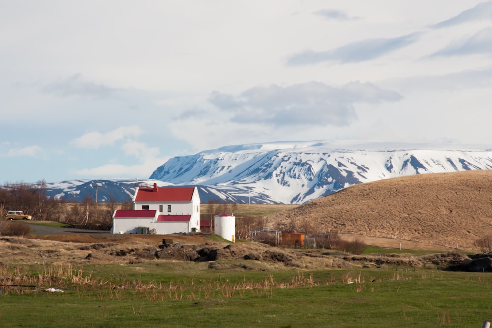 white and brown house near mountain under white sky during daytime