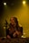 woman in black sleeveless top singing on stage
