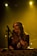 woman in black sleeveless top singing on stage