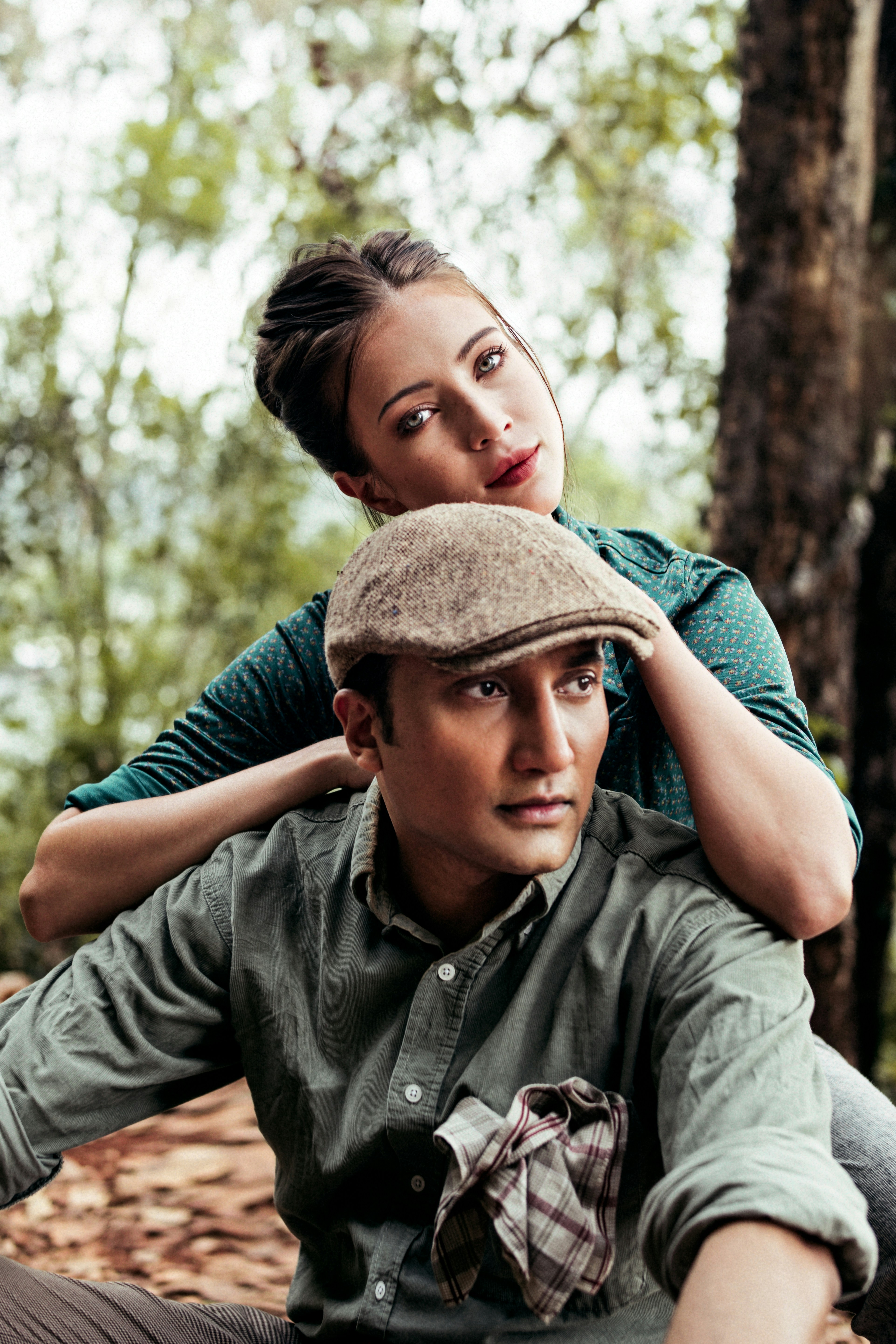 man in green button up shirt wearing brown hat