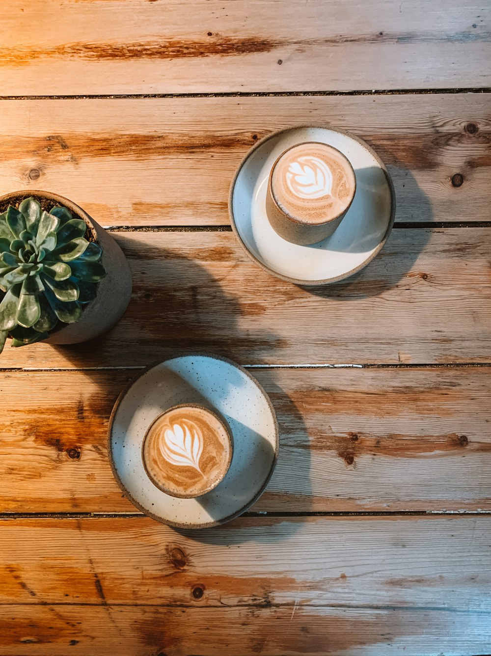 four white ceramic cups on brown wooden table