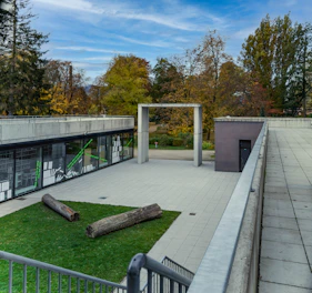 A modern corporate outdoor area featuring synthetic grass with sleek black and green accents.