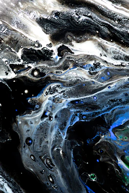 Abstract sound waves pulsing in silver and deep blue hues on a black canvas.