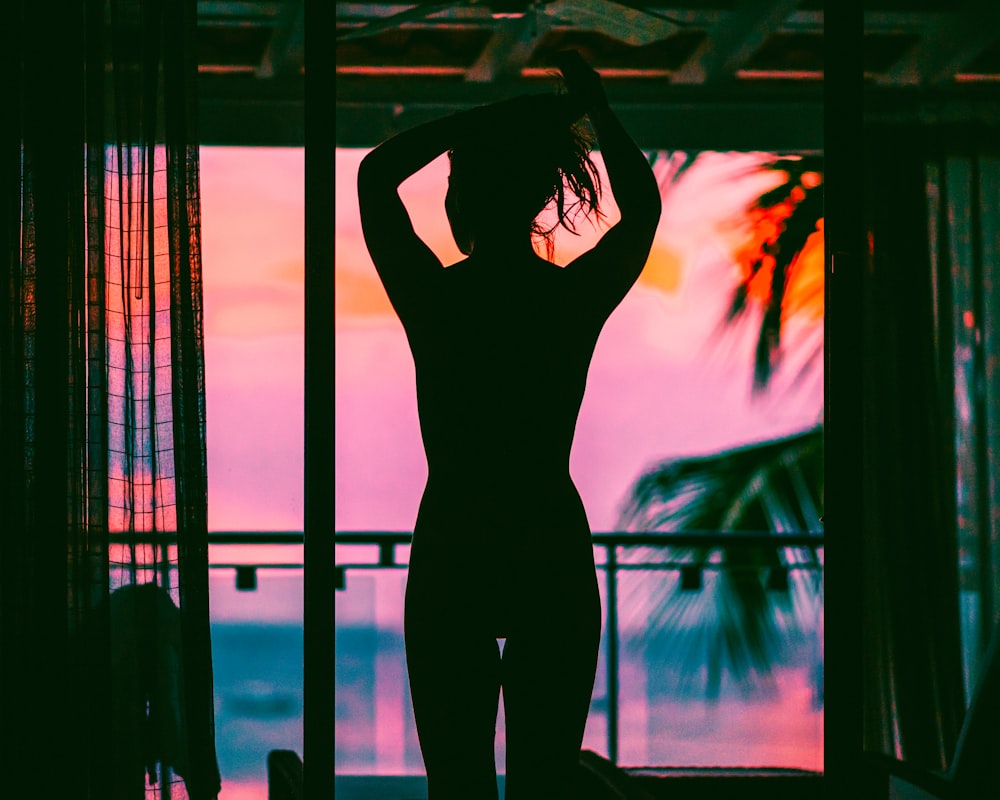 woman in black tank top and pants standing on black metal frame