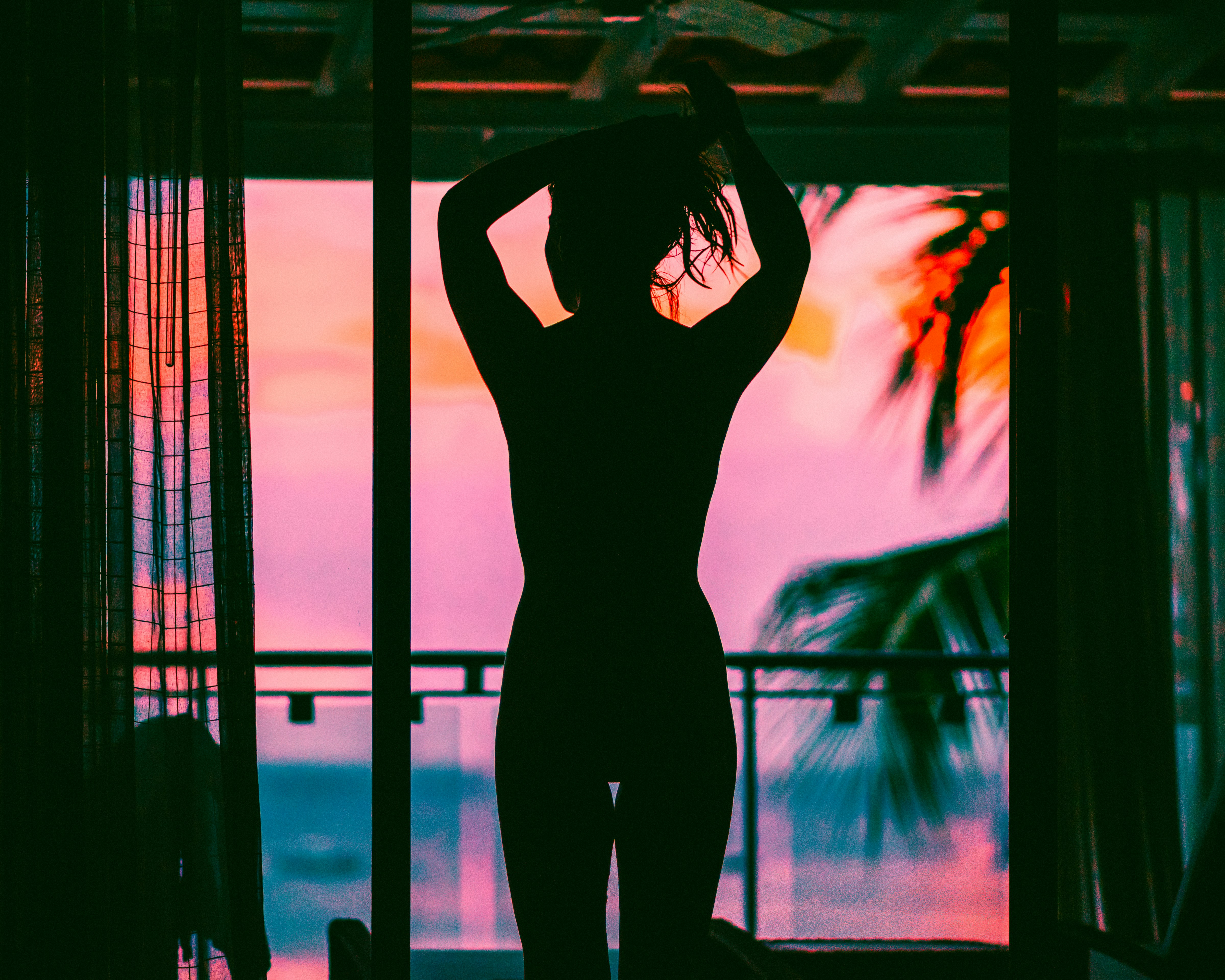 woman in black tank top and pants standing on black metal frame