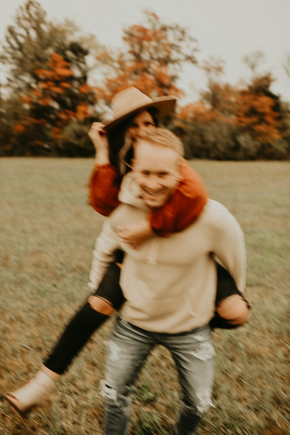 woman in white long sleeve shirt and brown hat