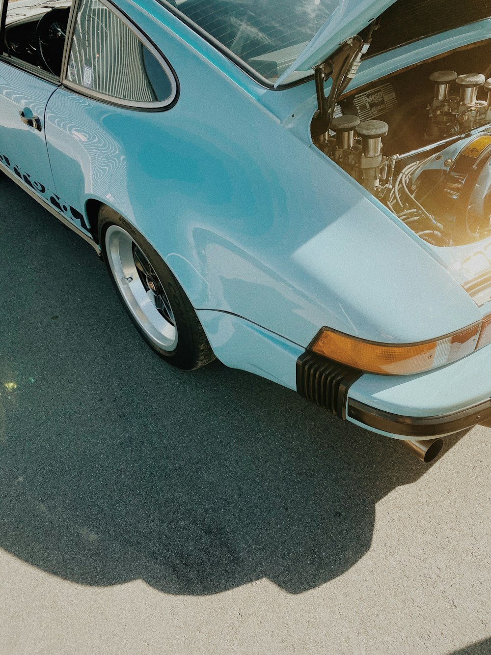 blue car with white and black stripe textile