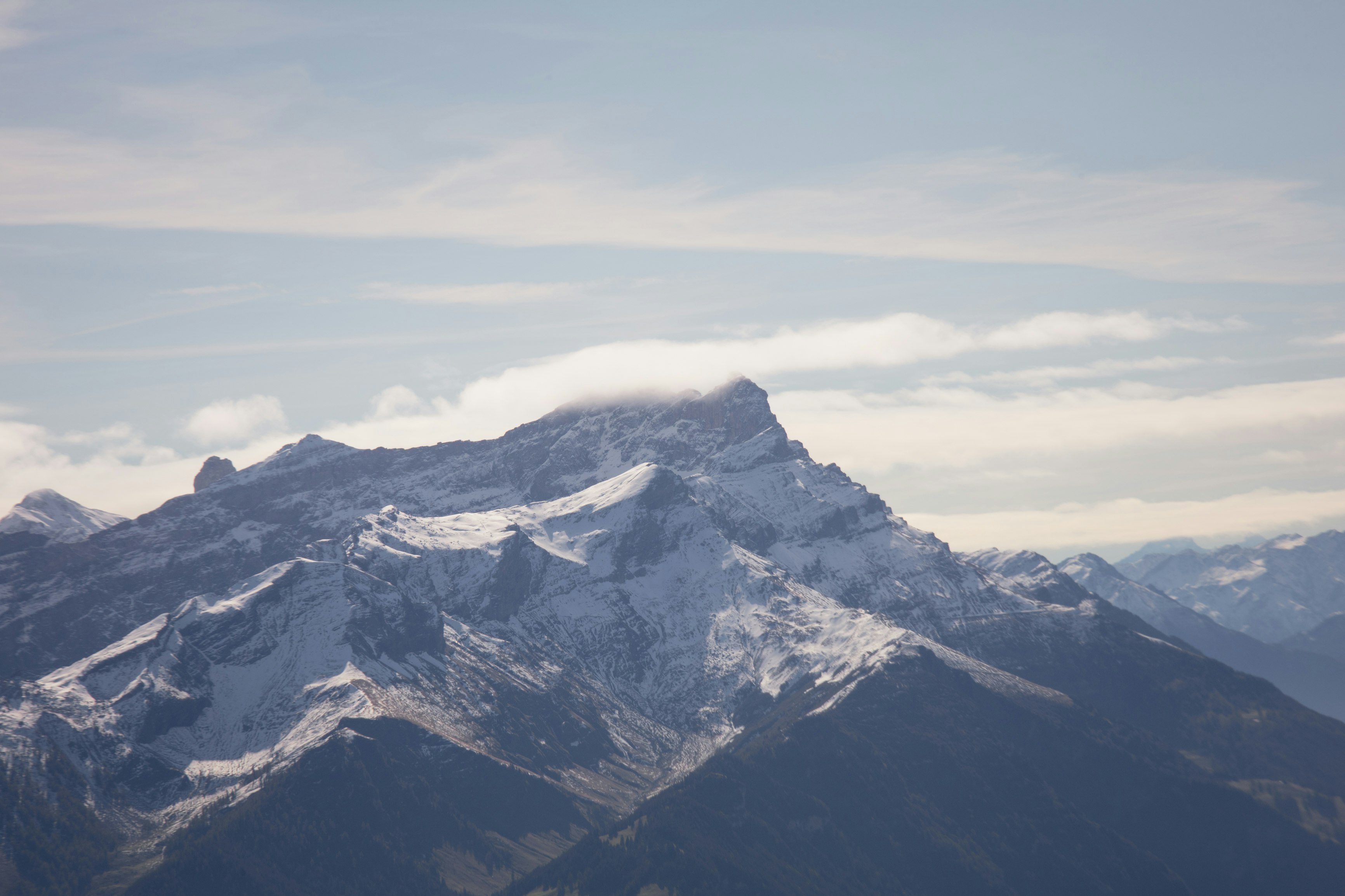 snow covered mountain under cloudy sky during daytime