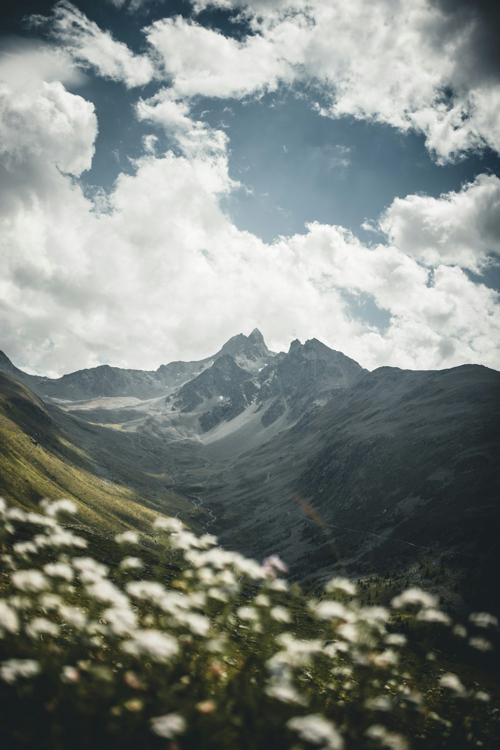 green mountains under white clouds and blue sky during daytime