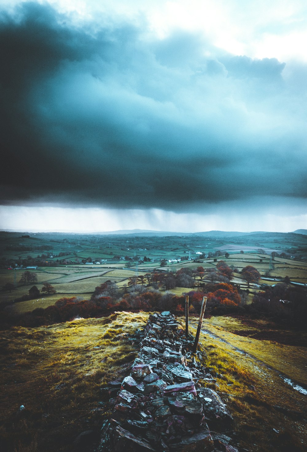 green grass field under cloudy sky during daytime