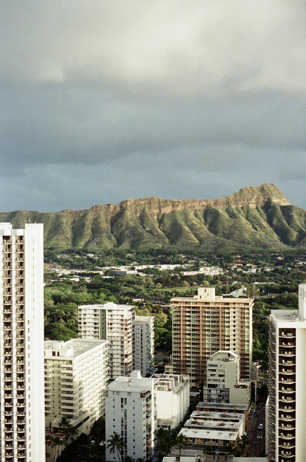 high rise buildings near mountain during daytime