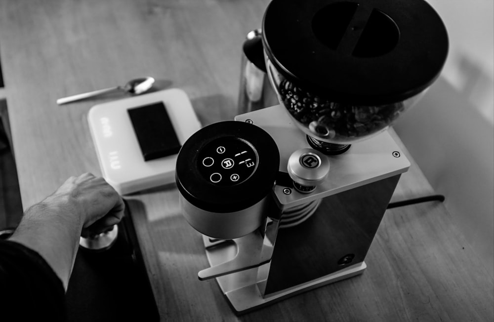 silver iphone 6 beside silver and black round container