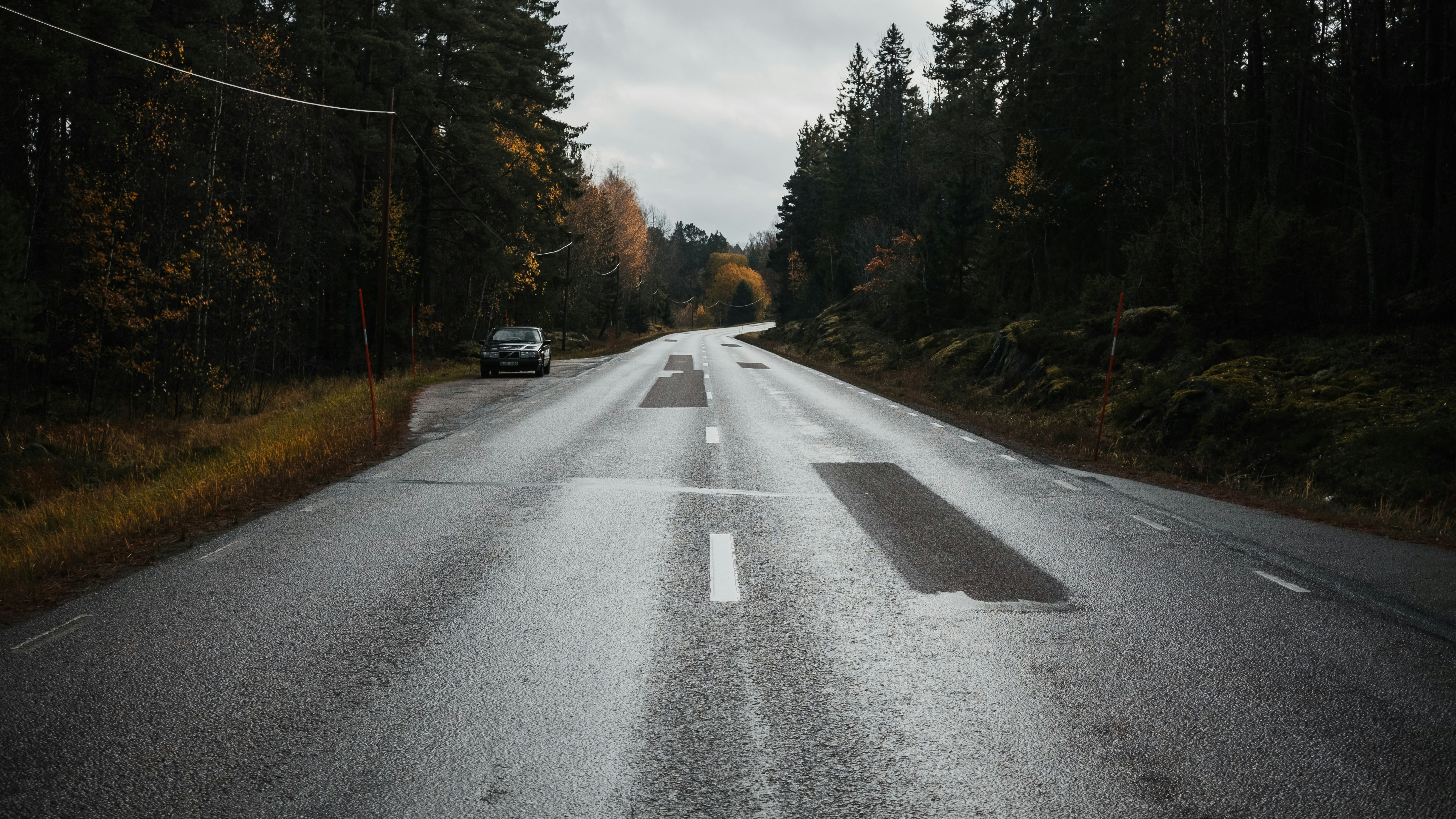 black car on gray asphalt road during daytime