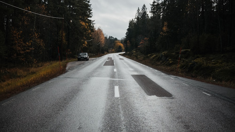 black car on gray asphalt road during daytime