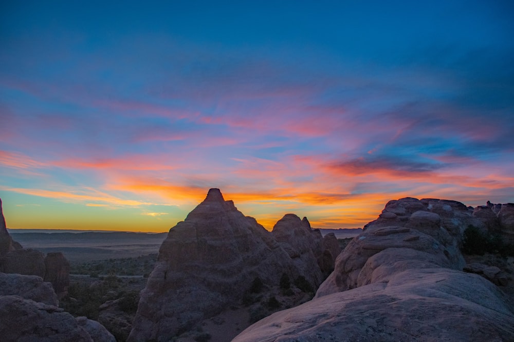 rocky mountain under blue sky during sunset