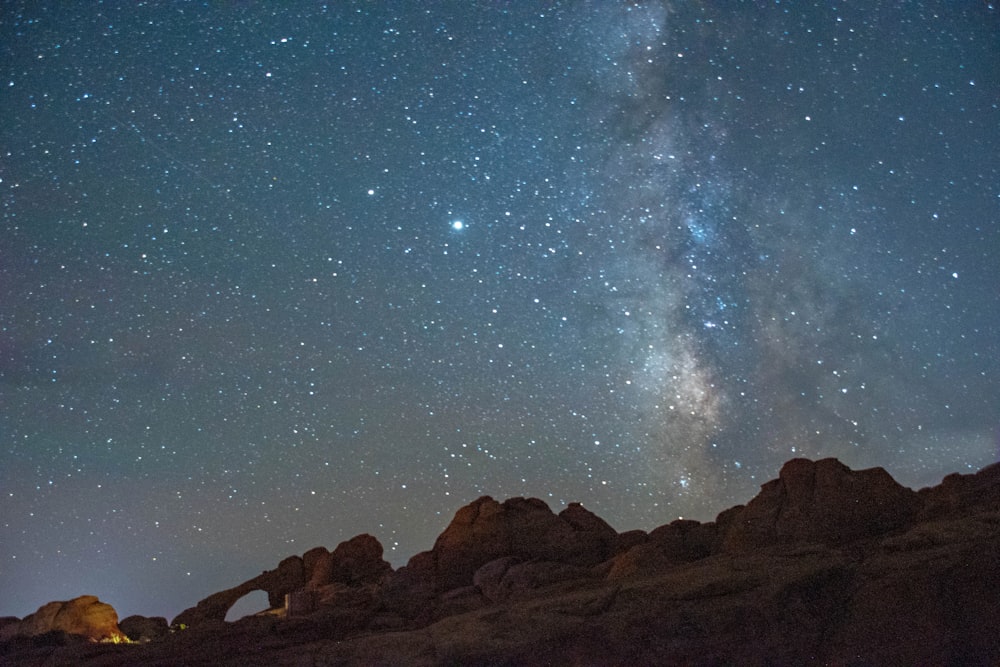 brown rocky mountain under starry night