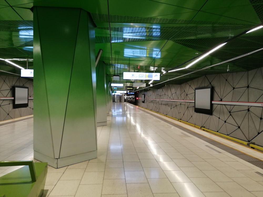 white tiled hallway with green walls