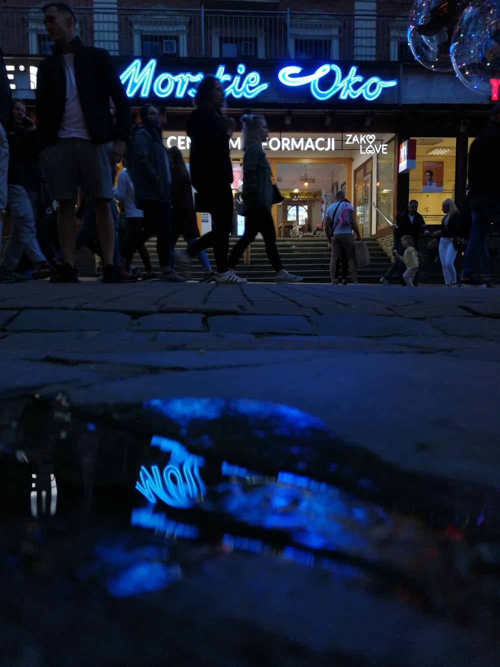 people walking on street during night time