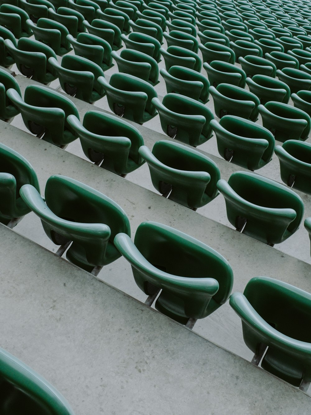 green plastic chairs on gray concrete floor