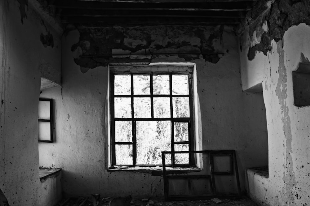 grayscale photo of window during daytime