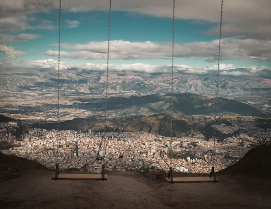 brown wooden swing on brown soil in Quito Ecuador