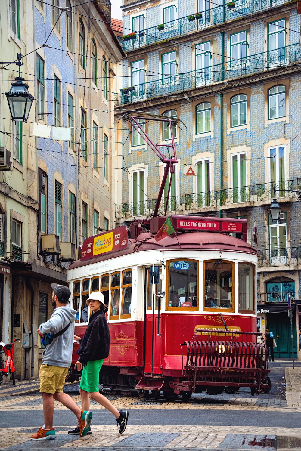 red and white tram on road near buildings during daytime