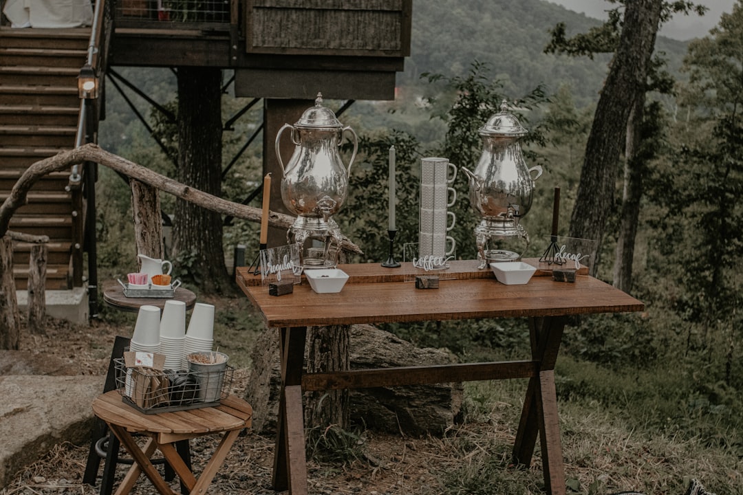 clear glass pitcher on brown wooden table