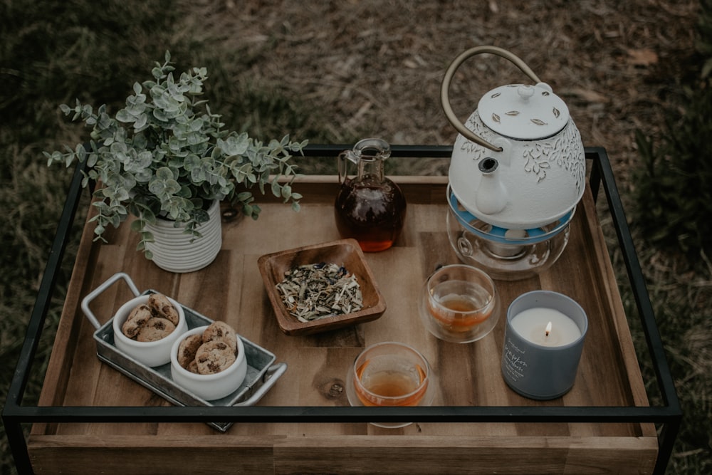 clear glass jar beside white ceramic bowl on brown wooden table