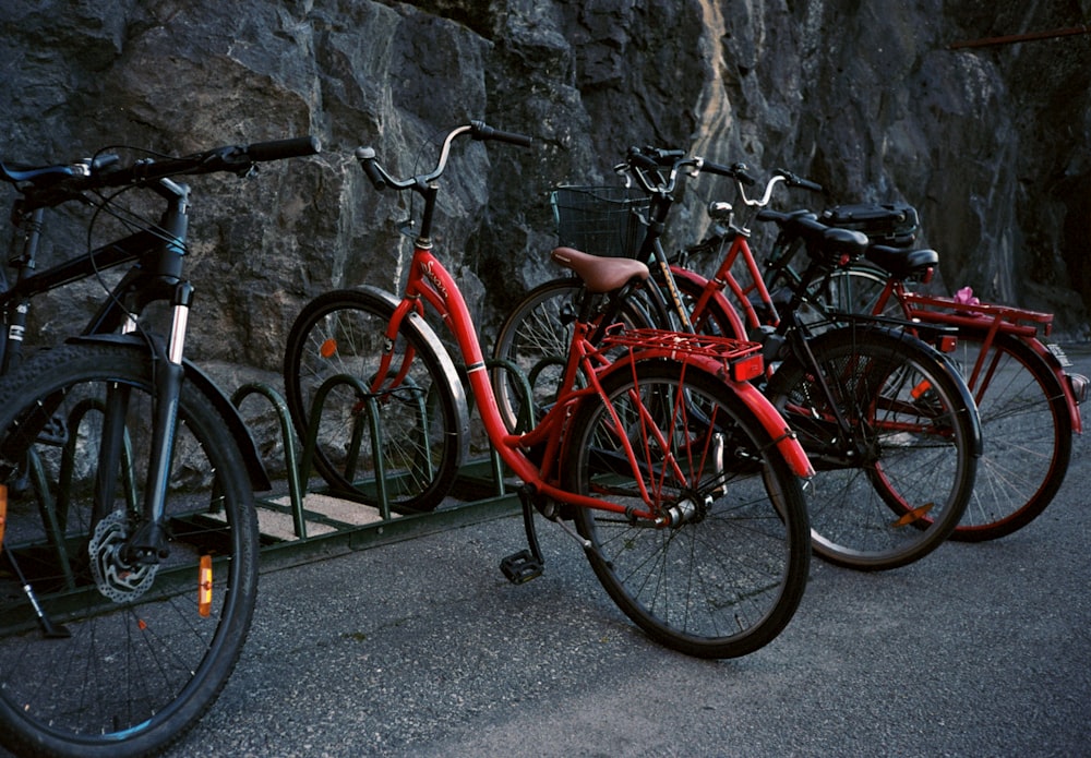 red city bike leaning on wall