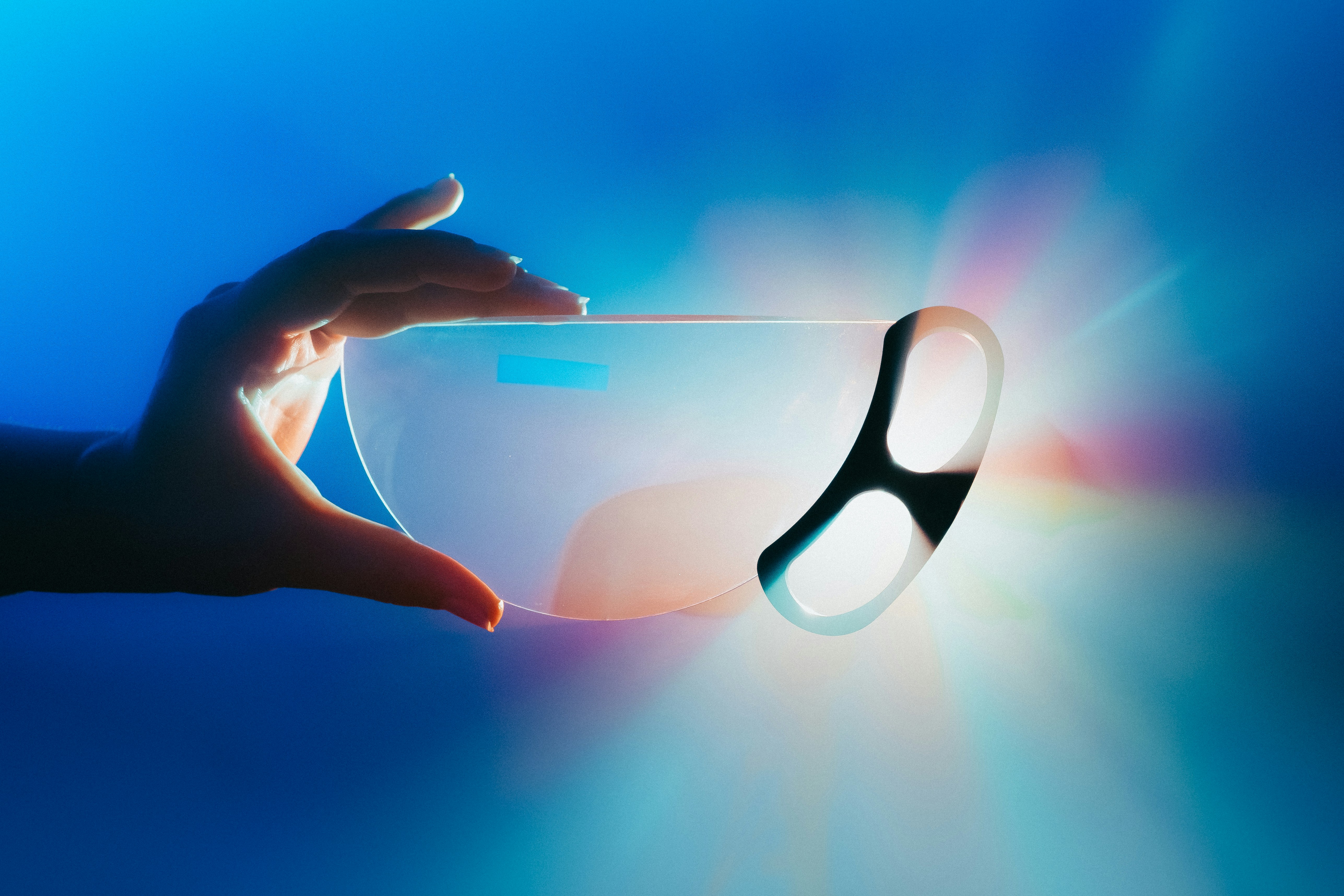 hands holding sleek lightweight augmented reality glasses