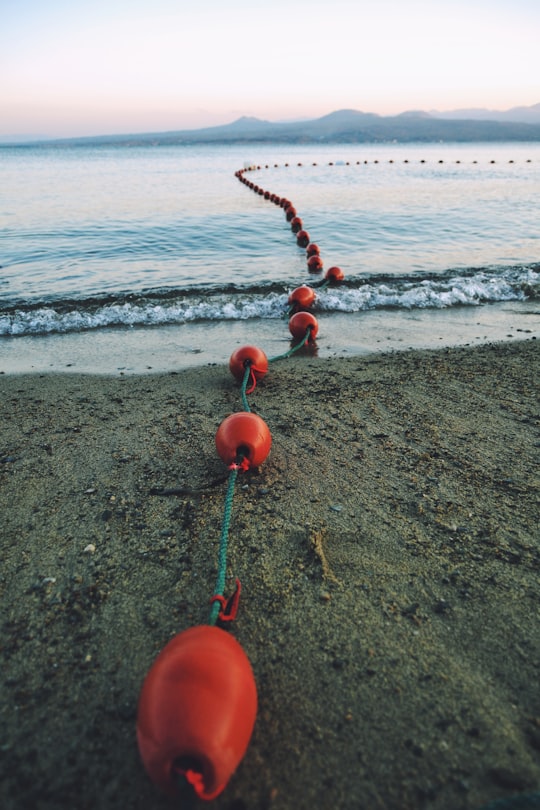 red tomato on beach shore during daytime in Sevan Lake Armenia