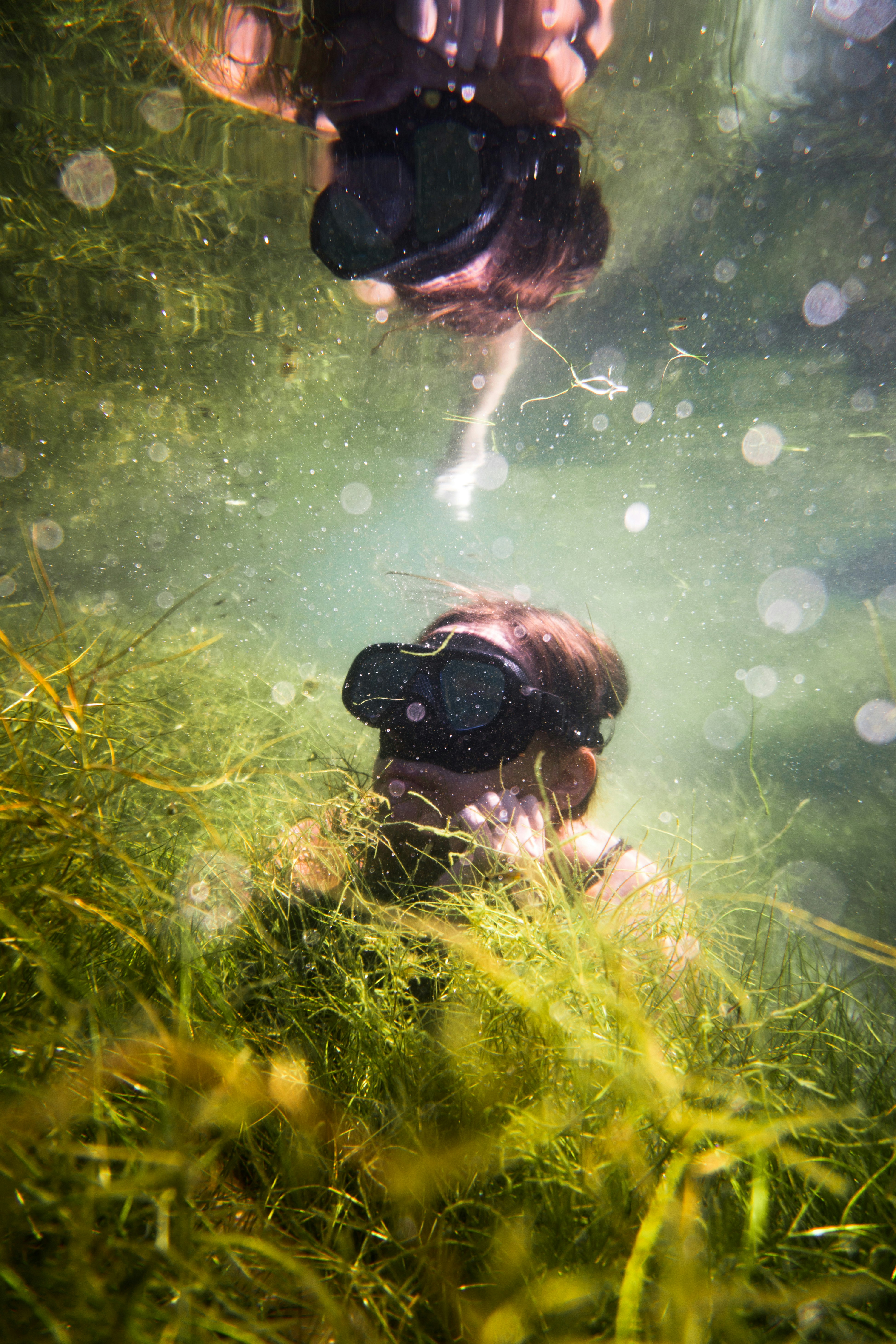 man-in-black-goggles-and-goggles-in-water