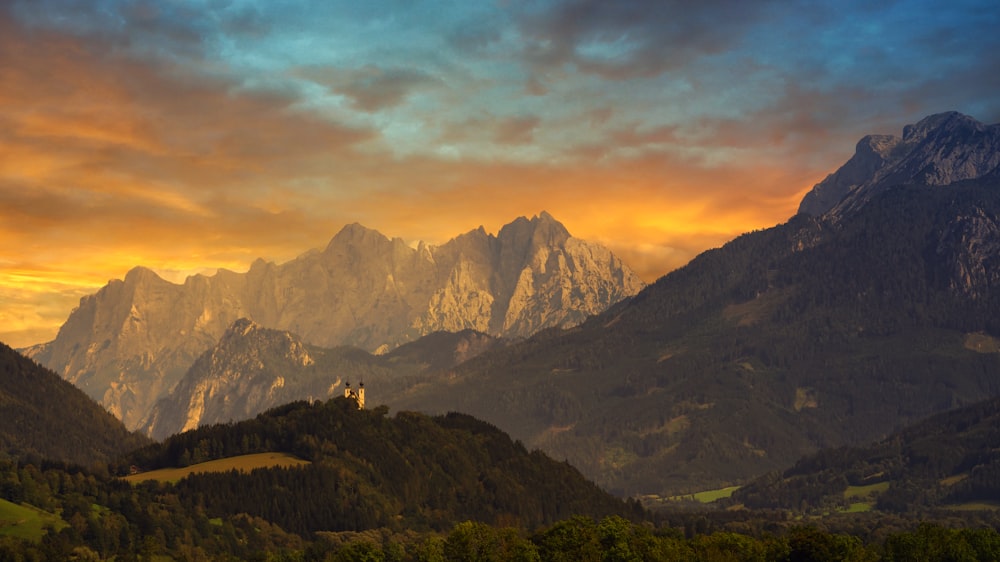 green and brown mountains under cloudy sky during daytime