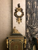 An elegant clock with a sleek design in a living room setting.