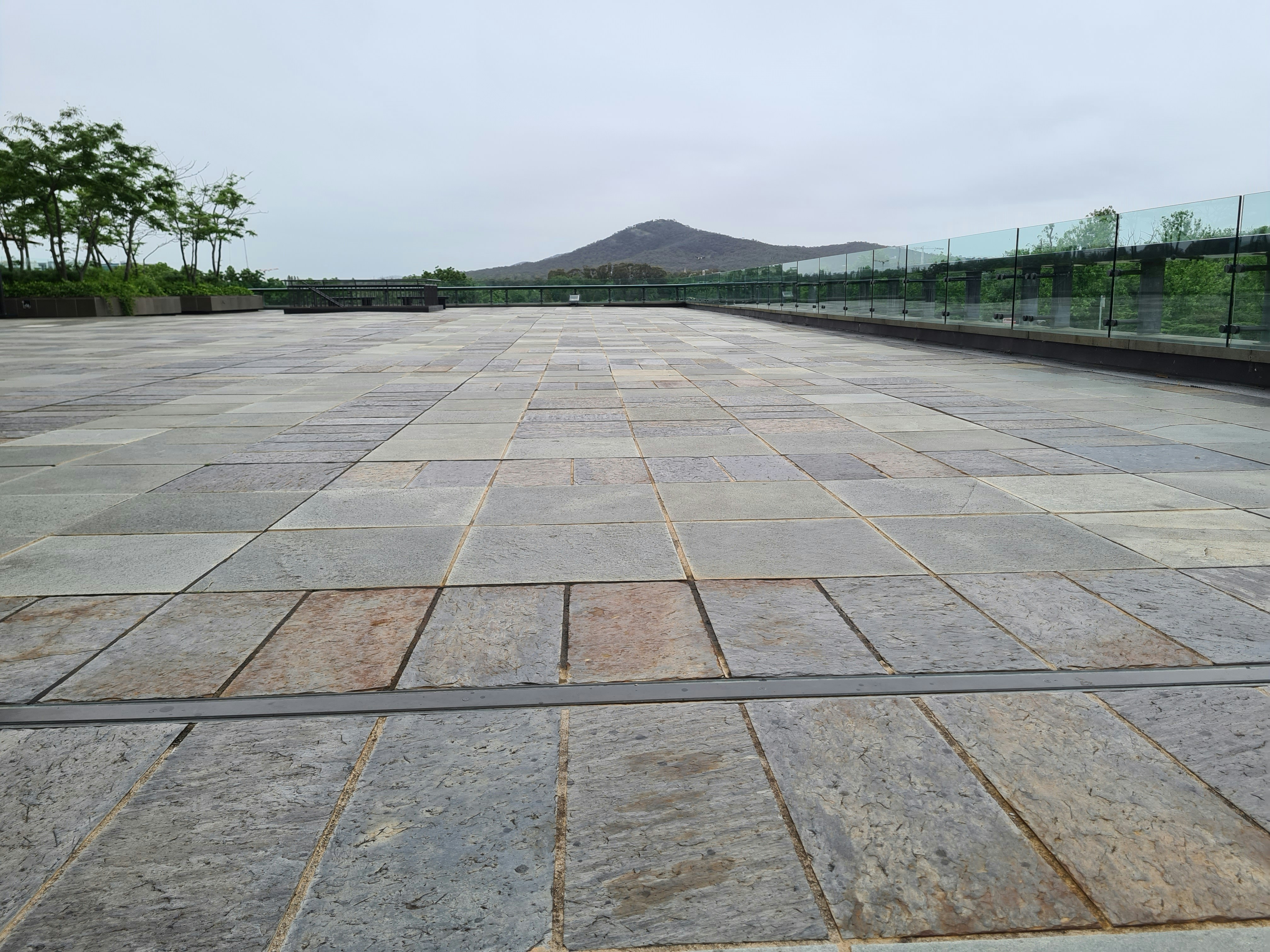 Beautiful natural stone flagstone patio with mountain views, outdoor furniture, and surrounding landscape plantings